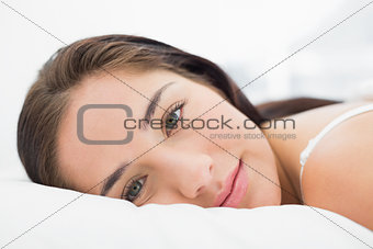 Close up of a pretty woman resting in bed