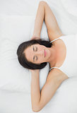 Beautiful woman sleeping in bed with eyes closed