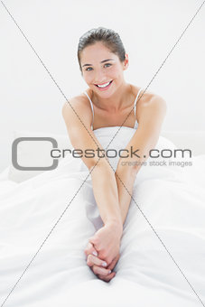 Portrait of a woman smiling in bed