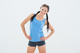 Smiling woman in sportswear and plaits