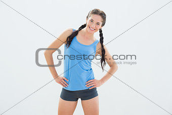 Smiling woman in sportswear and plaits