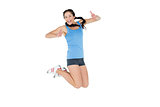 Sporty young woman jumping mid air