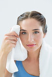 Close up of a woman wiping sweat with towel
