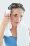 Woman wiping sweat with towel