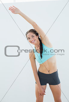 Portrait of a smiling young woman stretching hand