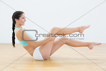 Profile shot of a slim woman sitting in sportswear