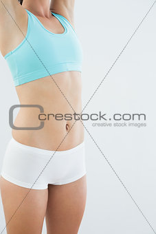 Mid section of a fit young woman in sportswear