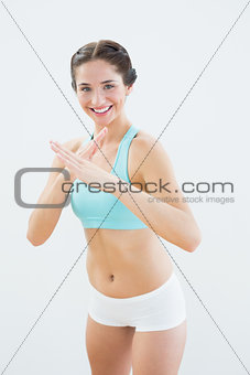 Portrait of a smiling fit young woman in defending posture