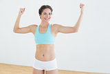 Fit woman in sportswear standing with clenched fists