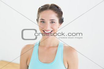 Smiling young woman in blue sports bra