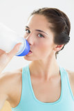 Close up of a woman drinking water at the gym