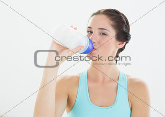 Portrait of a sporty woman drinking water