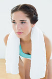 Close up of a tired woman with towel around neck