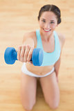 Woman with dumbbell at fitness studio