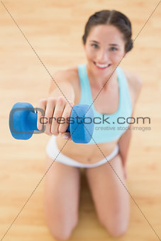 Woman with dumbbell at fitness studio