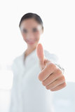 Blurred business woman gesturing thumbs up