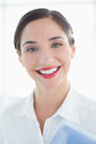 Close up of a smiling business woman in white shirt