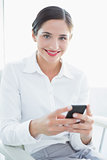 Smiling business woman with mobile phone