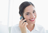 Smiling business woman using mobile phone