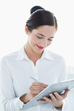 Smiling business woman with clipboard and pen