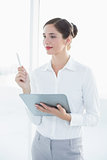Young business woman with clipboard and pen