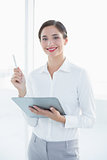 Business woman with clipboard and pen in office