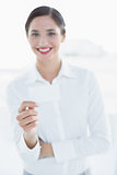 Smiling business woman with hand gesture