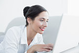 Close up side view of a beautiful woman using laptop