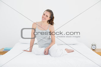 Young woman sitting in bed