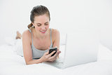 Relaxed casual woman using cellphone and laptop
