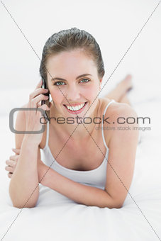 Portrait of a woman using mobile phone in bed