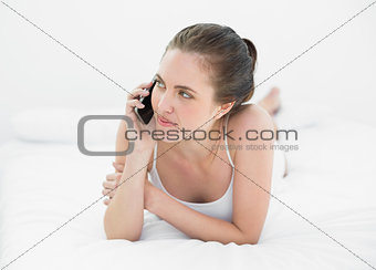 Woman using mobile phone in bed