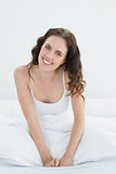 Portrait of a beautiful woman smiling in bed