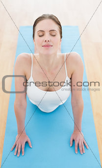 Beautiful woman stretching on exercise mat