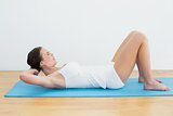 Side view of woman exercise on mat
