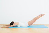 Side view of woman exercising on mat