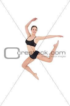 Sporty woman jumping isolated on white background
