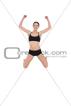 Sporty young woman jumping isolated on white background