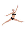 Sporty woman jumping on white background