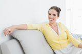Portrait of a relaxed woman sitting on sofa