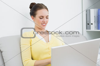 Casual woman using laptop at home