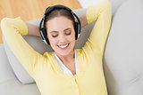 Woman enjoying music through headphones