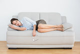 Full length of a well dressed woman sleeping on sofa