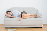 Well dressed young woman sleeping on sofa