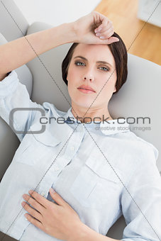 Well dressed young woman lying on sofa