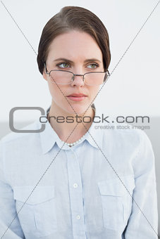 Displeased young woman wearing eye glasses