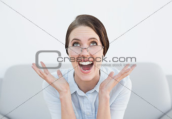 Close up of a displeased woman screaming on sofa