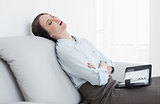 Well dressed woman sitting and sleeping on sofa