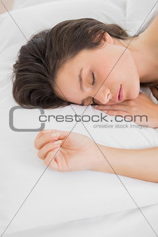 Pretty young woman sleeping in bed