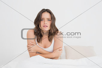 Sleepy woman sitting in bed